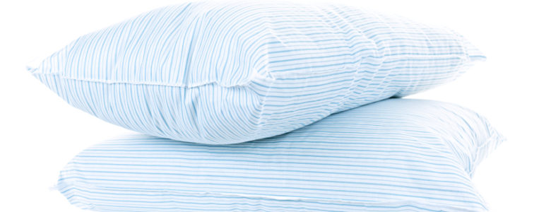 Two soft pillows with blue striped covers isolated on white background